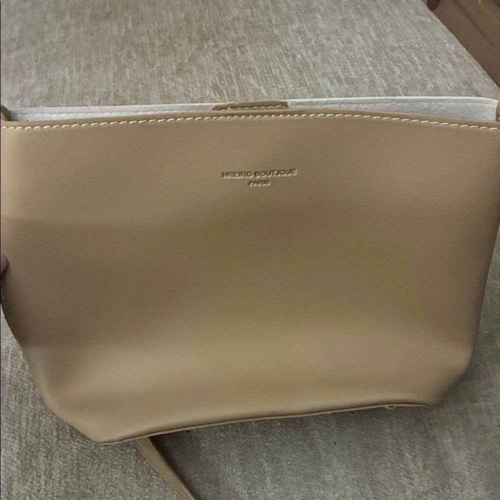 Tan purse with sleek design and smooth finish.